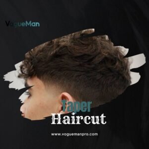 Man with curly hair styled in a low taper haircut, featuring a gradual taper on the sides and back.